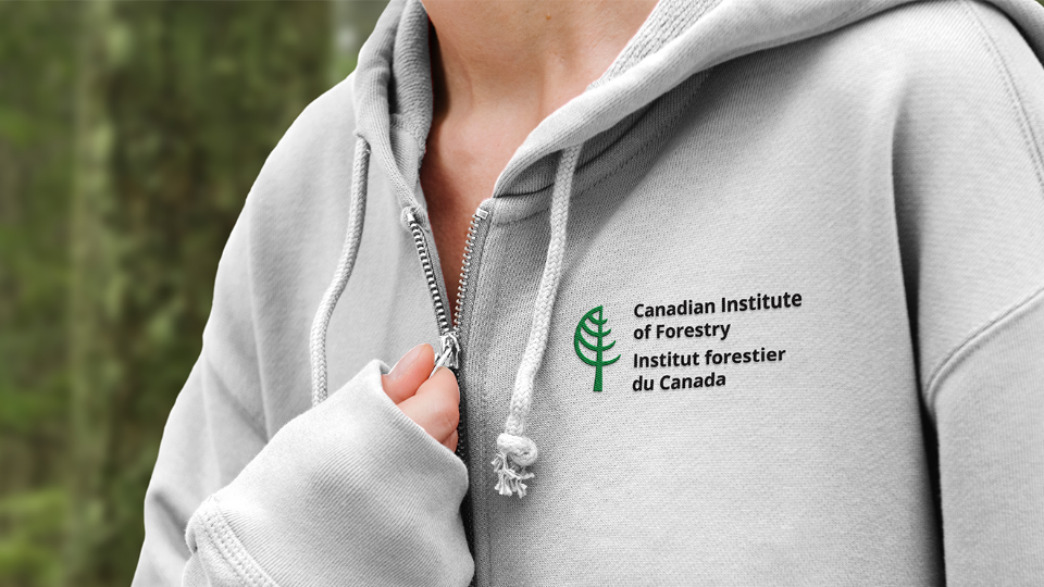 Hoodie-2 Woman wearing zip-up hoodie with CIF-IFC logo.