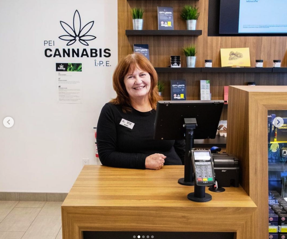 PEI-Cannabis-staff-01 Friendly PEI Cannabis staff member smiling in uniform.