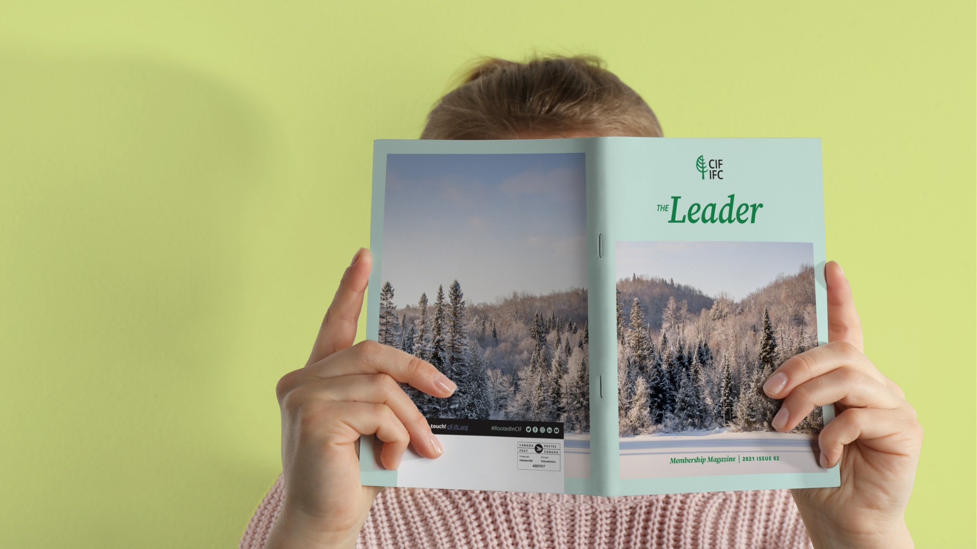 The-Leader-1 A young woman holding up the membership magazine, The Leader, in front of her face.