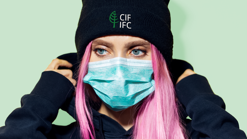 Toque Woman wearing a black toque with CIF-IFC logo.