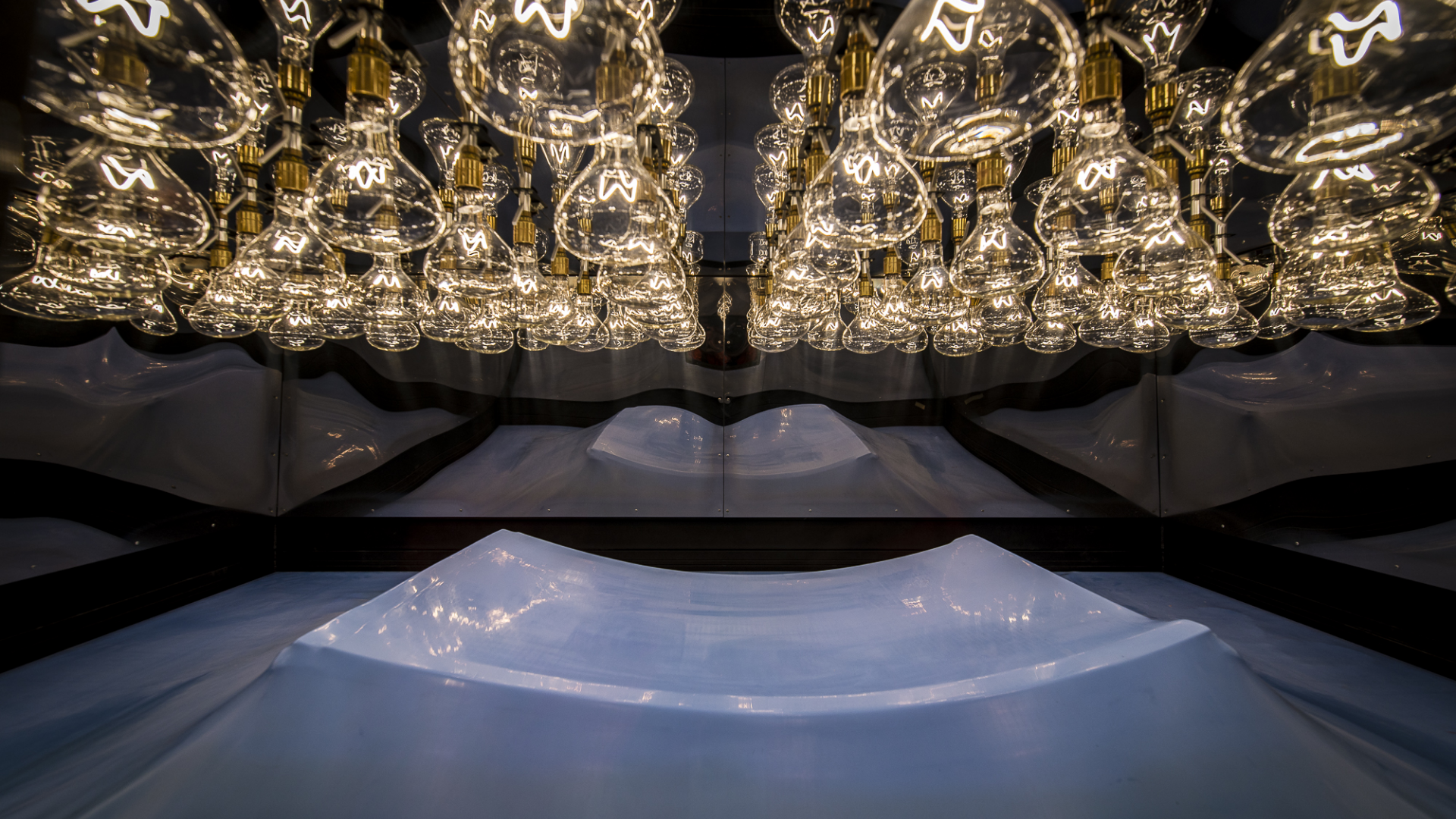 Chorus-Aviation-Frame-13 Hundreds of lightbulbs suspended over a plastic casing inside the vacuum sealer.